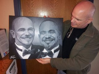 PHOTO: A pleased client picks up the portrait of his late husband painted with traces of his ashes.